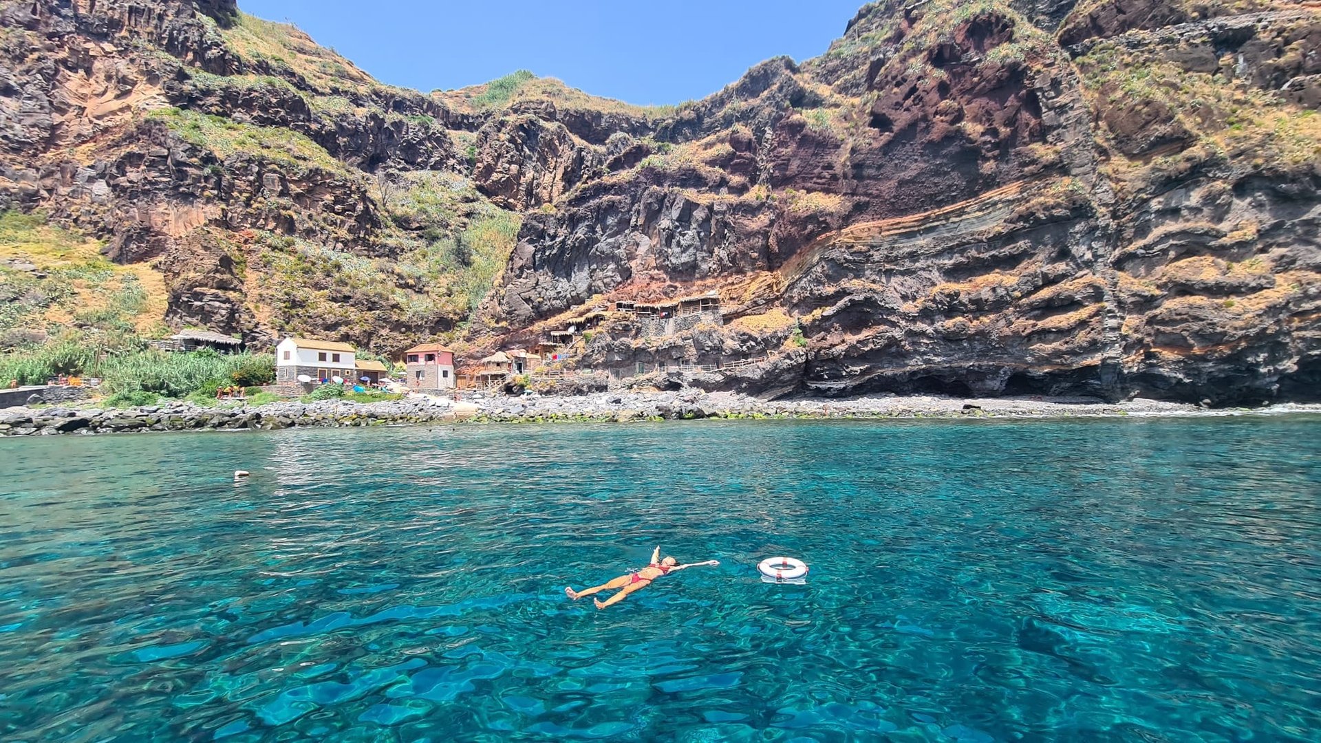 Turquoise water and layered cliffs along the route